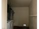 Utility room featuring a washing machine, water heater, and shelf at 7732 Blackbird Ave, Las Vegas, NV 89145