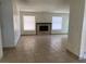Living room featuring tile floors, windows, and a fireplace at 7732 Blackbird Ave, Las Vegas, NV 89145