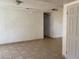 Living room with tile floors and a white front door at 7732 Blackbird Ave, Las Vegas, NV 89145