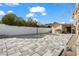 Spacious backyard featuring a stone-paved area with a basketball hoop and a charming shed at 7797 Hauck St, Las Vegas, NV 89139
