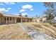 Spacious backyard features a covered patio, mature trees, and a grassy area at 7797 Hauck St, Las Vegas, NV 89139