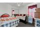 This bedroom features twin beds with red accents, a mirrored closet, and bright natural light at 7797 Hauck St, Las Vegas, NV 89139