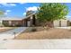 Brick home features a well-manicured yard, mature trees, and a multi-car garage at 7797 Hauck St, Las Vegas, NV 89139