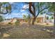 Charming home featuring a well-manicured front yard with mature trees and a rock garden at 7797 Hauck St, Las Vegas, NV 89139