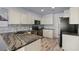 Kitchen featuring granite countertops, modern appliances, white cabinets, and tiled backsplash at 7797 Hauck St, Las Vegas, NV 89139