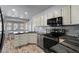 Well-lit kitchen with stainless steel appliances, granite countertops, and a breakfast nook at 7797 Hauck St, Las Vegas, NV 89139
