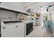 Efficient laundry room with modern machines, shelving and an outdoor access point at 7797 Hauck St, Las Vegas, NV 89139