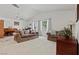 Bright living room features neutral carpet, ceiling fan, two windows and comfortable seating at 7797 Hauck St, Las Vegas, NV 89139