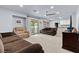 Spacious living room featuring a ceiling fan, large windows and an adjacent kitchen area at 7797 Hauck St, Las Vegas, NV 89139