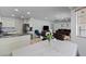 Open-concept living space featuring a modern kitchen, dining area, and comfortable seating at 7797 Hauck St, Las Vegas, NV 89139