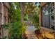 Picturesque backyard featuring a winding stone path, mature trees, stone accents and landscape lighting at 812 Eaglewood Dr, Las Vegas, NV 89144