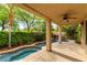 This backyard has a covered patio overlooking a waterfall feature and lush garden at 812 Eaglewood Dr, Las Vegas, NV 89144