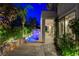 Backyard with covered patio, stunning pool, waterfall feature, and lush landscaping at 812 Eaglewood Dr, Las Vegas, NV 89144