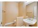 Powder room featuring a pedestal sink, mirror, and tile flooring at 812 Eaglewood Dr, Las Vegas, NV 89144
