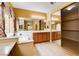 Bathroom with double sinks, tub, and a full wall of mirrored cabinets at 812 Eaglewood Dr, Las Vegas, NV 89144