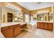 Bathroom boasts double sinks, tub, warm lighting, and lots of mirrors at 812 Eaglewood Dr, Las Vegas, NV 89144