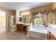 Bright bathroom features soaking tub, vanity, and a separate shower at 812 Eaglewood Dr, Las Vegas, NV 89144