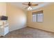 Simple bedroom with neutral carpet, window with shade, and a ceiling fan at 812 Eaglewood Dr, Las Vegas, NV 89144