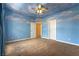 Bedroom featuring carpet flooring, custom painted sky-themed walls, and two doors at 812 Eaglewood Dr, Las Vegas, NV 89144