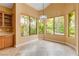 Bright dining area with tile floor, chandelier, and large windows with backyard views at 812 Eaglewood Dr, Las Vegas, NV 89144