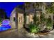 Exterior view of home featuring a covered patio and backyard pool with rock waterfall at 812 Eaglewood Dr, Las Vegas, NV 89144