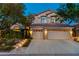 Charming two-story home featuring a three-car garage and a beautifully landscaped front yard at 812 Eaglewood Dr, Las Vegas, NV 89144