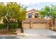Charming two-story home with a three-car garage, landscaped front yard and well-maintained desert landscape at 812 Eaglewood Dr, Las Vegas, NV 89144