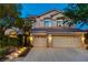 Charming two-story home featuring a three-car garage and a beautifully landscaped front yard at 812 Eaglewood Dr, Las Vegas, NV 89144
