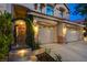 Inviting front entrance with illuminated stone steps and a charming wrought iron gate at 812 Eaglewood Dr, Las Vegas, NV 89144