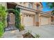 Inviting front entrance with illuminated stone steps and a charming wrought iron gate at 812 Eaglewood Dr, Las Vegas, NV 89144