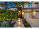 Inviting front entrance with illuminated stone steps and a charming wrought iron gate at 812 Eaglewood Dr, Las Vegas, NV 89144