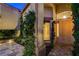 Charming front entrance featuring lush greenery and a well-lit pathway to the front door at 812 Eaglewood Dr, Las Vegas, NV 89144