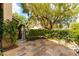 Private courtyard featuring stone pavers, mature landscaping, an iron gate and a soothing water feature at 812 Eaglewood Dr, Las Vegas, NV 89144