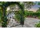 Beautifully designed wrought iron gate providing access to the front yard and lush landscaping at 812 Eaglewood Dr, Las Vegas, NV 89144