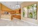 Open kitchen featuring light wood cabinets, tile flooring, stainless steel appliances, and natural light at 812 Eaglewood Dr, Las Vegas, NV 89144