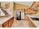 Bright kitchen featuring wood cabinetry, tile flooring, and stainless steel appliances at 812 Eaglewood Dr, Las Vegas, NV 89144