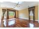 Bright living room boasting hardwood floors, a ceiling fan, and large windows with decorative window treatments at 812 Eaglewood Dr, Las Vegas, NV 89144