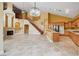 Open-concept living space with tile floors, staircase, fireplace, and kitchen view at 812 Eaglewood Dr, Las Vegas, NV 89144