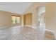 Expansive living area with vaulted ceilings, arched doorways, neutral walls, and tile flooring at 812 Eaglewood Dr, Las Vegas, NV 89144