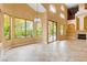 Spacious living room with large windows, tile floors, and access to the backyard pool area at 812 Eaglewood Dr, Las Vegas, NV 89144