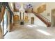 Open living area with soaring ceilings, a fireplace, access to the backyard, and a staircase to the upper level at 812 Eaglewood Dr, Las Vegas, NV 89144