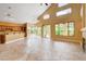 Spacious living area with a fireplace, bar, access to the kitchen, and sliding glass doors to backyard at 812 Eaglewood Dr, Las Vegas, NV 89144