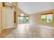 Bright, open living room with vaulted ceilings, neutral walls, tile flooring, and multiple windows offering views of the outside at 812 Eaglewood Dr, Las Vegas, NV 89144