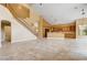 Spacious living area with a staircase, tile flooring, bar area, and open access to kitchen at 812 Eaglewood Dr, Las Vegas, NV 89144