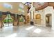 Bright and spacious living room with soaring ceilings, a fireplace, and large windows with decorative curtains at 812 Eaglewood Dr, Las Vegas, NV 89144