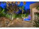 Covered patio area with pool, waterfall feature, lush landscaping, and outdoor seating at 812 Eaglewood Dr, Las Vegas, NV 89144