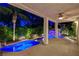 Covered patio overlooking a uniquely designed pool with a rock waterfall and meticulous landscaping at 812 Eaglewood Dr, Las Vegas, NV 89144