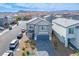 View of a two-story home with a gray tile roof in a quiet residential neighborhood at 9871 Magnus Ct, Las Vegas, NV 89178