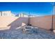 Landscaped backyard with a brick fire pit, decorative lighting, and desert landscaping at 9871 Magnus Ct, Las Vegas, NV 89178