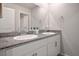 Bathroom featuring double sink vanity with granite countertop and white cabinetry at 9871 Magnus Ct, Las Vegas, NV 89178